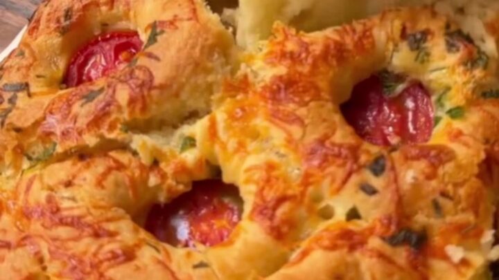 Golden pull-apart bread rolls with melted cheese stretching between them.