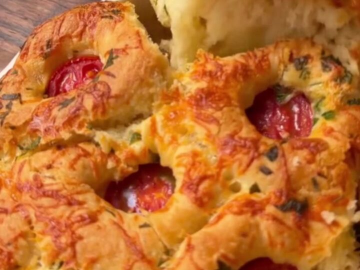 Golden pull-apart bread rolls with melted cheese stretching between them.