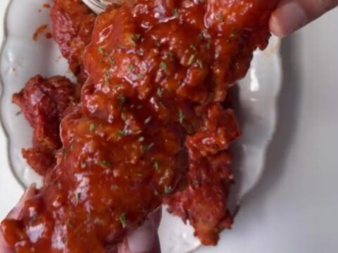 Crispy honey BBQ chicken tenders on a plate with creamy dip