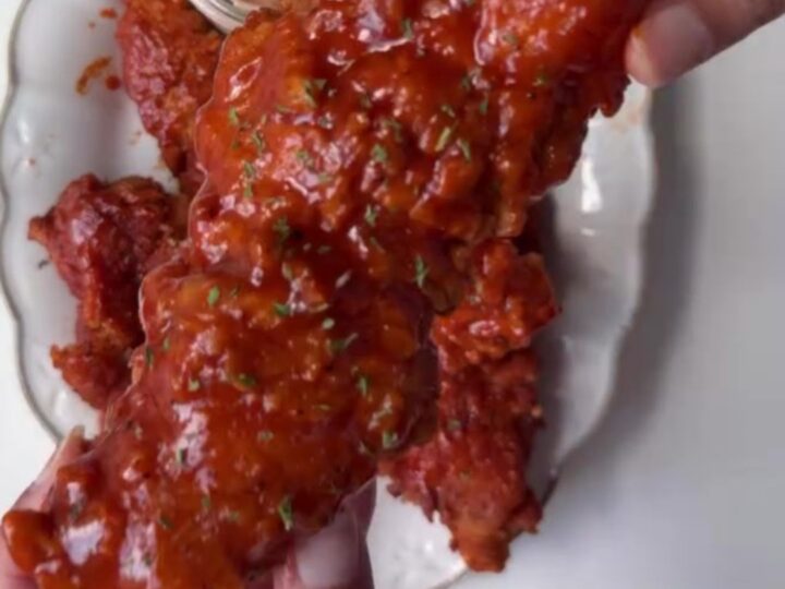 Crispy honey BBQ chicken tenders on a plate with creamy dip
