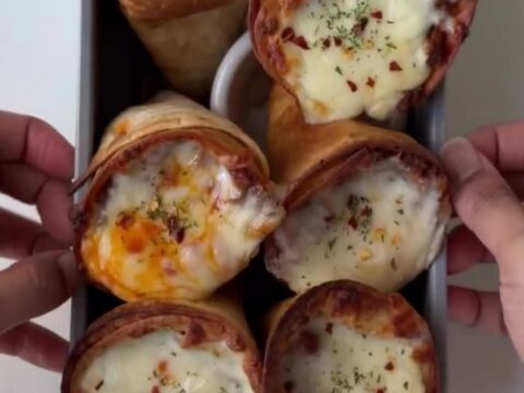 Crispy golden tortilla cones filled with seasoned beef and peppers, topped with bubbling melted mozzarella.