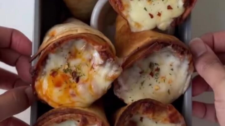 Crispy golden tortilla cones filled with seasoned beef and peppers, topped with bubbling melted mozzarella.