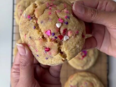 Thick sugar cookies with pink and red sprinkles, showing a soft, buttery center