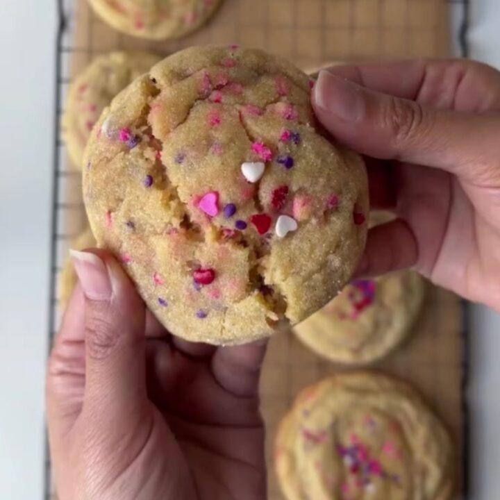 Thick sugar cookies with pink and red sprinkles, showing a soft, buttery center