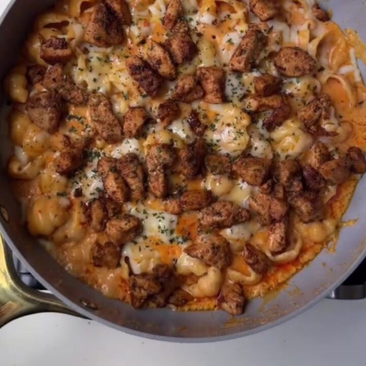 Spicy chili chicken penne in a creamy parmesan sauce, garnished with fresh parsley and chili flakes