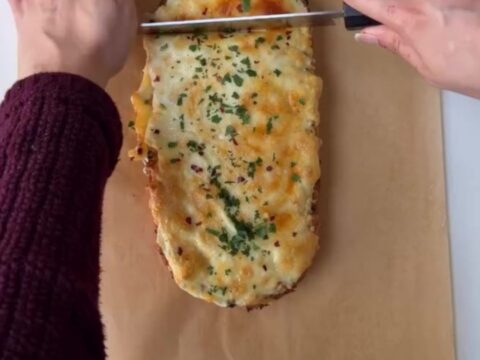 Pull-apart bread with roasted garlic butter and melted mozzarella, golden and blistered on top