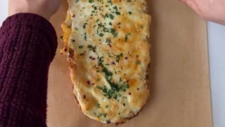 Pull-apart bread with roasted garlic butter and melted mozzarella, golden and blistered on top
