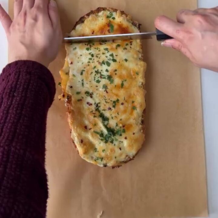 Pull-apart bread with roasted garlic butter and melted mozzarella, golden and blistered on top