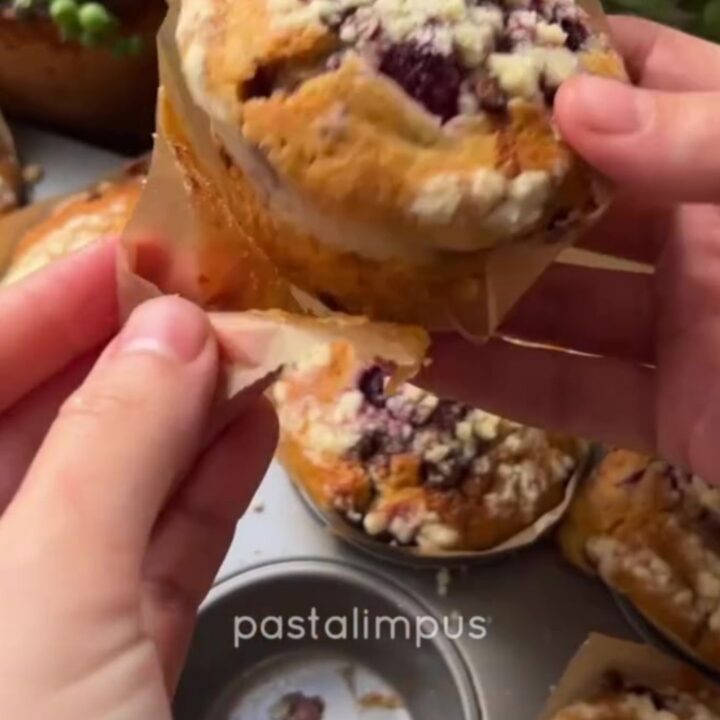 Golden raspberry chocolate chip muffins with streusel topping on a cooling rack