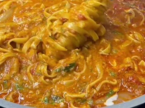 One-pot fettuccine with garden vegetables, topped with melted mozzarella and fresh parsley.