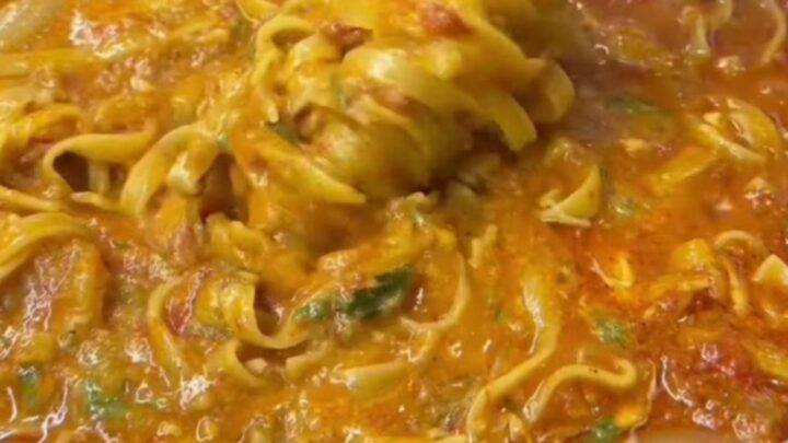 One-pot fettuccine with garden vegetables, topped with melted mozzarella and fresh parsley.