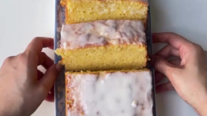 Sliced lemon glaze pound cake with glossy glaze and tender crumb