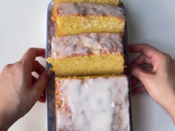 Sliced lemon glaze pound cake with glossy glaze and tender crumb