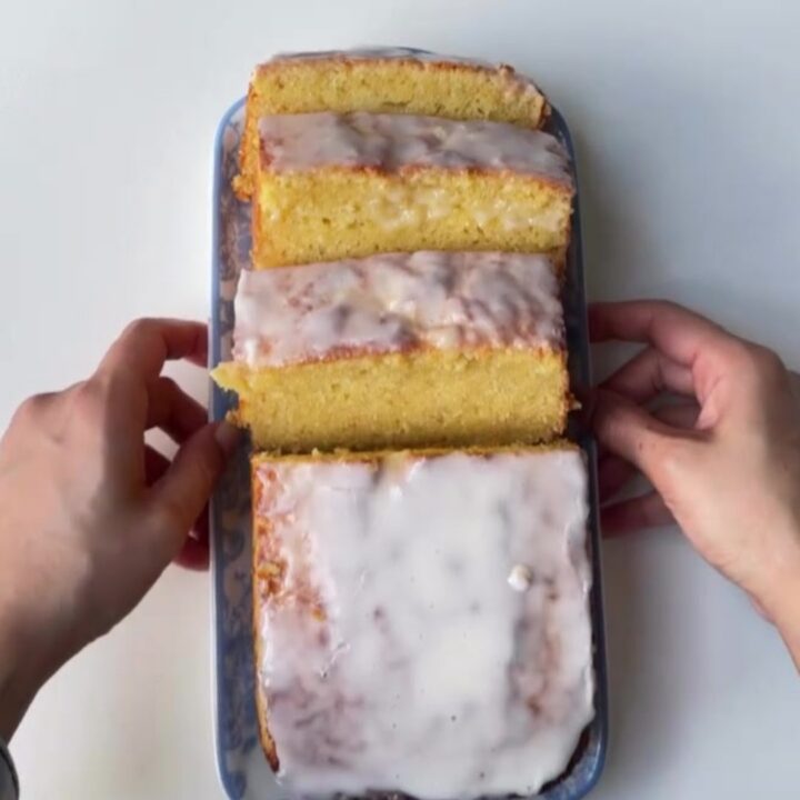 Sliced lemon glaze pound cake with glossy glaze and tender crumb