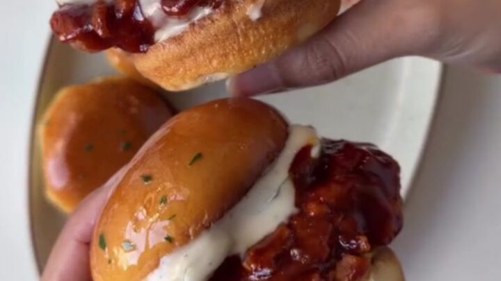 Hot honey chicken slider with crispy chicken, slaw, and pickles on a brioche bun