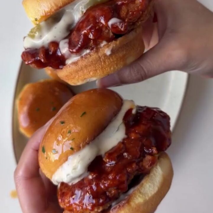 Hot honey chicken slider with crispy chicken, slaw, and pickles on a brioche bun
