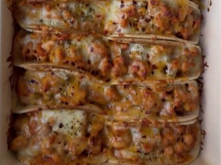 Cheesy taco boat skillet with melted cheese, chipotle drizzle, and cilantro