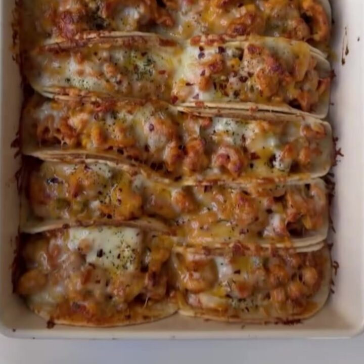 Cheesy taco boat skillet with melted cheese, chipotle drizzle, and cilantro