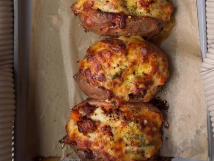 Loaded sweet potato skins with spiced beef and melted cheddar, garnished with cilantro and sour cream