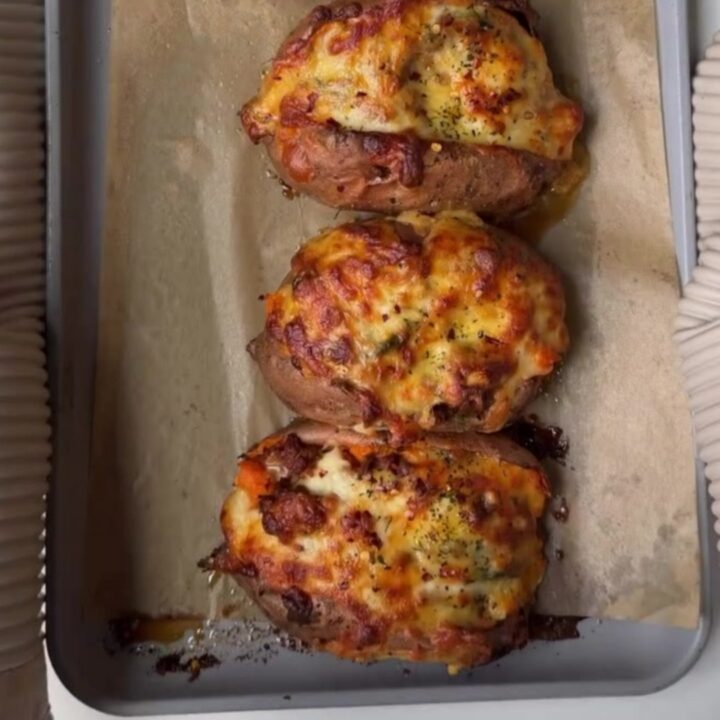 Loaded sweet potato skins with spiced beef and melted cheddar, garnished with cilantro and sour cream