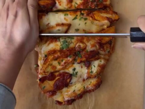 Loaded baguette with bubbling mozzarella and butter chicken, sliced to show cheese pull