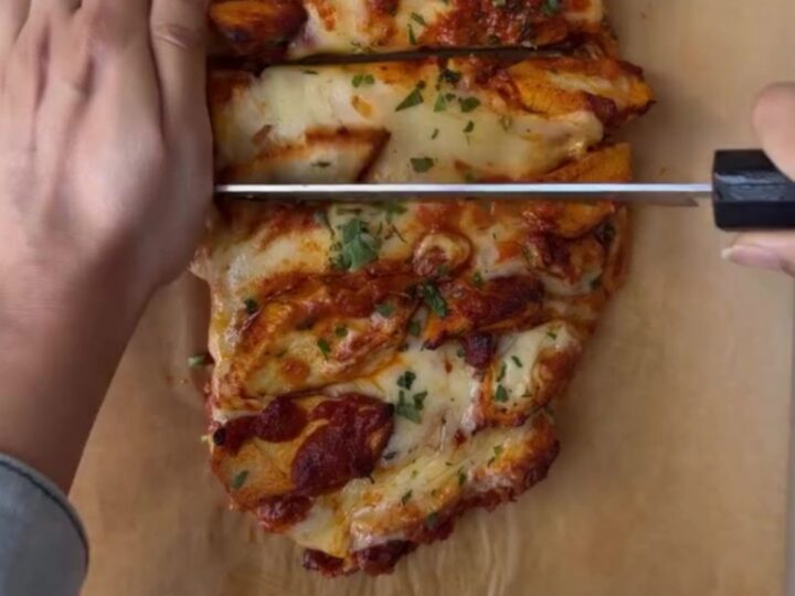 Loaded baguette with bubbling mozzarella and butter chicken, sliced to show cheese pull