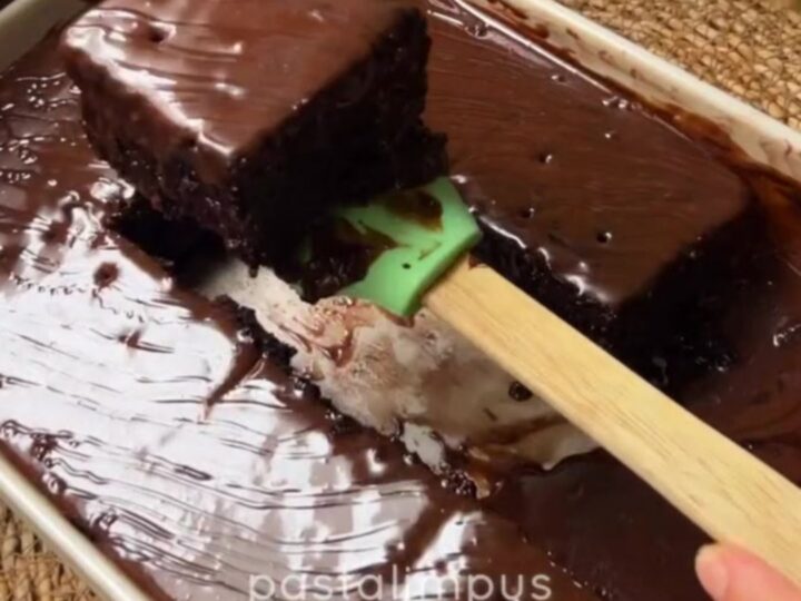 Fudgy chocolate cake squares topped with crushed pistachios and drizzled with chocolate syrup
