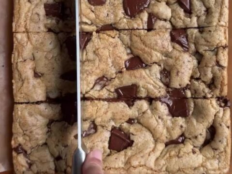 Warm brown butter chocolate chip blondies cut into squares with molten chocolate pools
