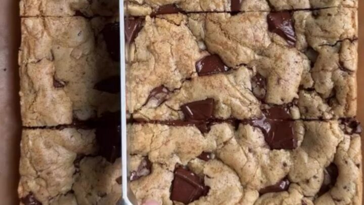Warm brown butter chocolate chip blondies cut into squares with molten chocolate pools