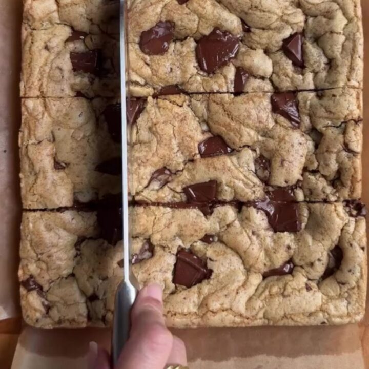 Warm brown butter chocolate chip blondies cut into squares with molten chocolate pools