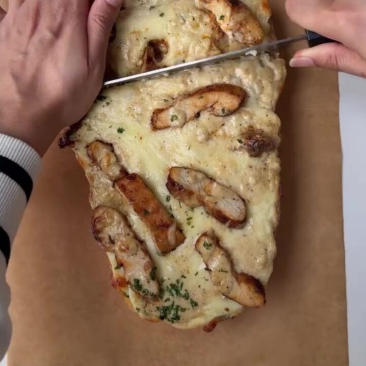 Crispy chicken Alfredo bake with blistered mozzarella and stringy cheese pull