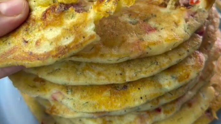 Giant stuffed pancake sliced into wedges, revealing melted cheese and sucuk pieces.
