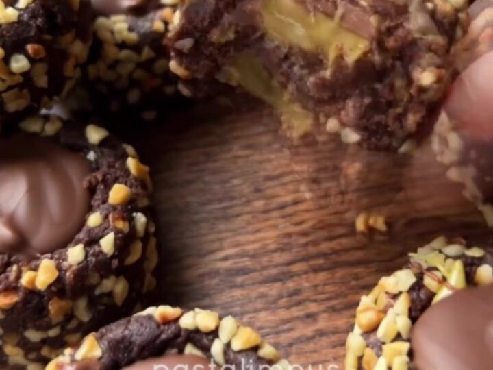 A pile of chocolate fudge bites with pistachio cream centers and chocolate drizzle