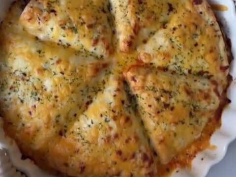 Golden hot pocket broken open showing gooey cheese pull and savory beef filling