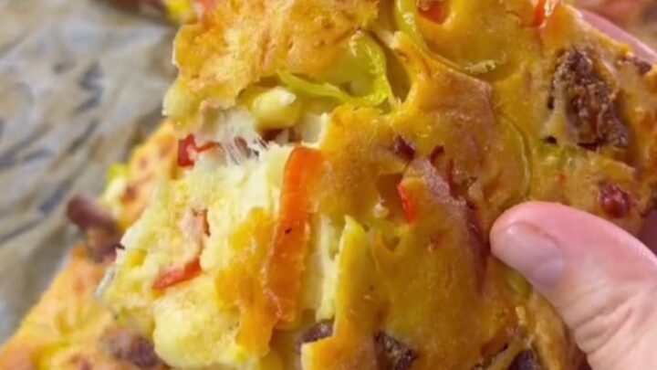 Golden sheet pan pizza cut into squares with melted cheese and pepperoni