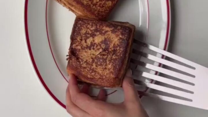 Crispy cinnamon roll French toast stack drizzled with cream cheese glaze