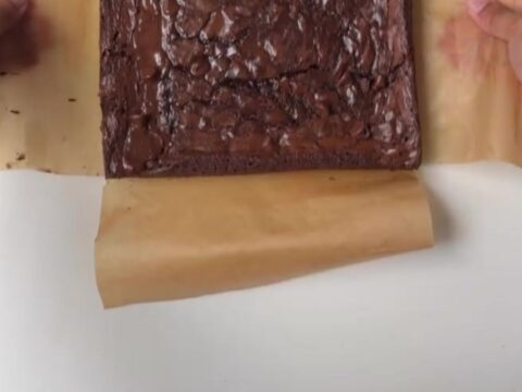 Sliced crinkle-top fudgy brownie showing crackly top and moist center