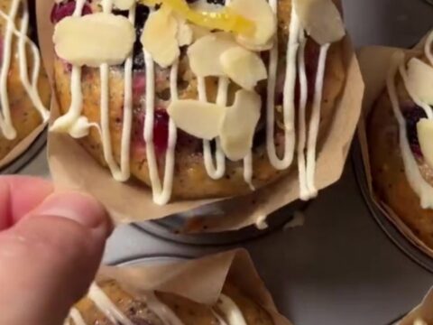 Whole lemon poppy seed berry cakes drizzled with white chocolate glaze on a wire rack