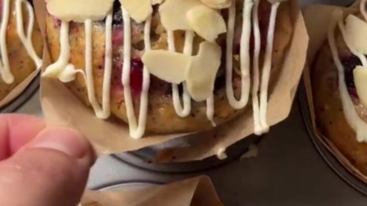 Whole lemon poppy seed berry cakes drizzled with white chocolate glaze on a wire rack