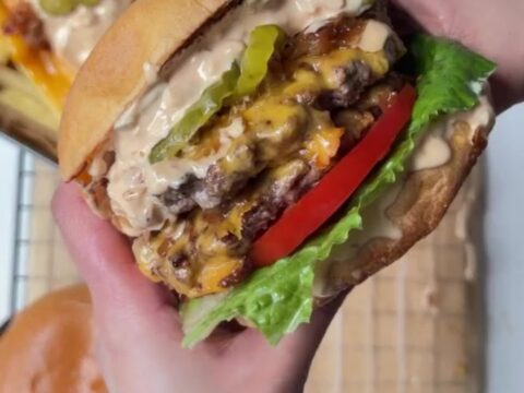 Smash burger with caramelized onions and melted cheese on a toasted bun