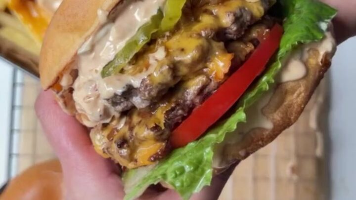 Smash burger with caramelized onions and melted cheese on a toasted bun