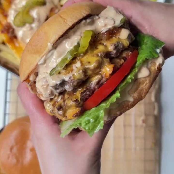 Smash burger with caramelized onions and melted cheese on a toasted bun