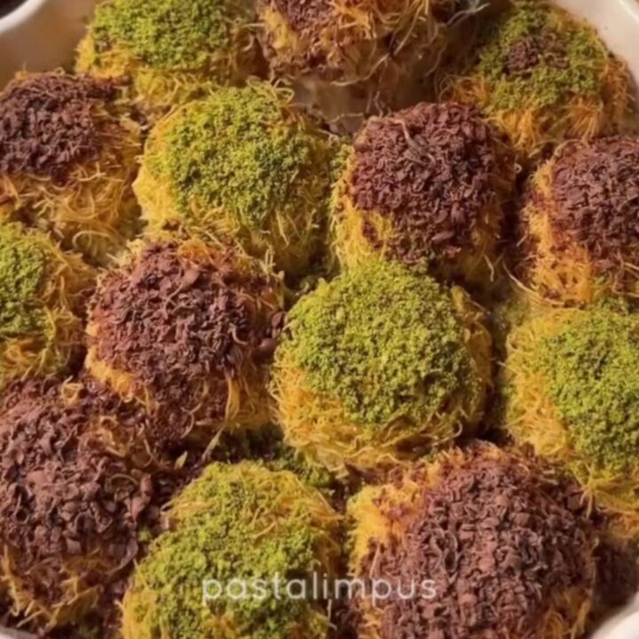 Chilled kadayıf dessert topped with dark chocolate shavings and chopped pistachios