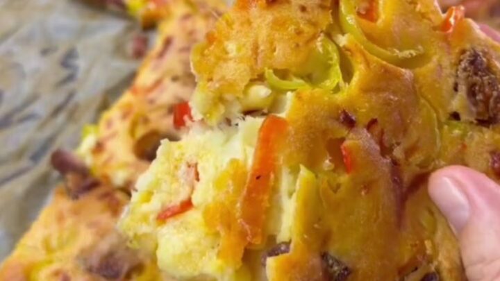 Golden puffy crepe pizza squares with melted mozzarella being pulled apart
