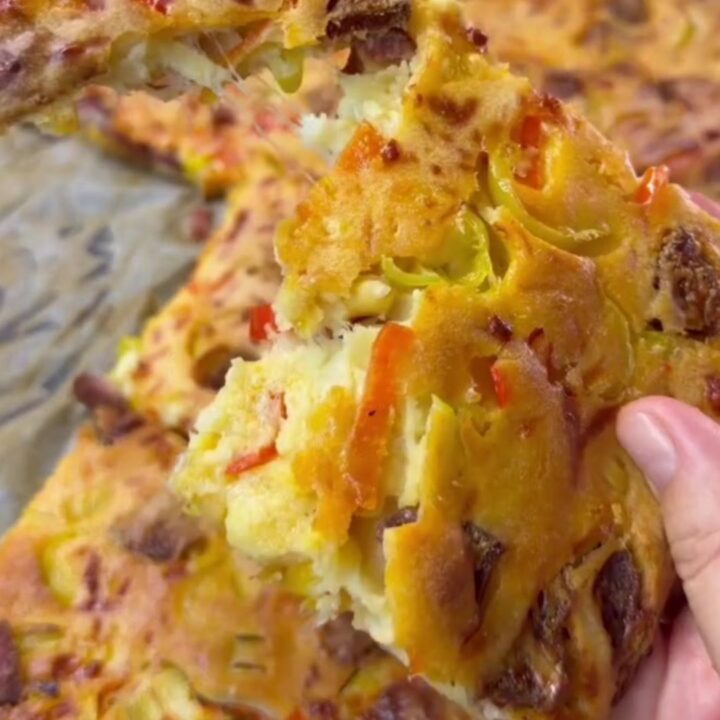 Golden puffy crepe pizza squares with melted mozzarella being pulled apart