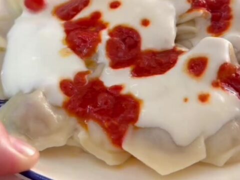 Honeycomb manti dumplings topped with garlic yogurt and drizzled with red paprika butter
