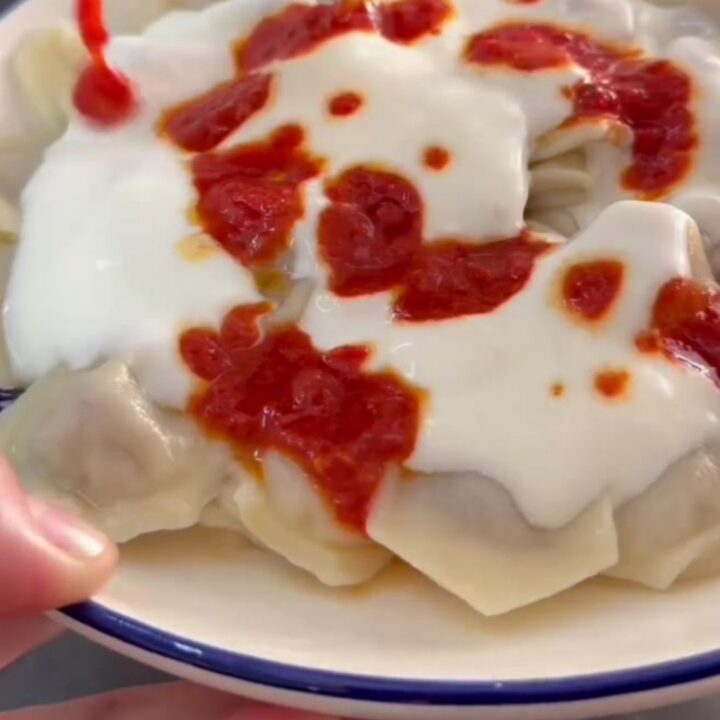 Honeycomb manti dumplings topped with garlic yogurt and drizzled with red paprika butter