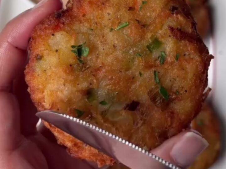 Crispy potato veggie patty being dipped into spicy Kewpie sauce, with melted cheddar visible