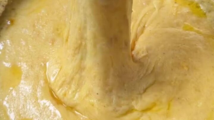 Black Sea kuymak in a copper pan with cheese pulling high on a fork