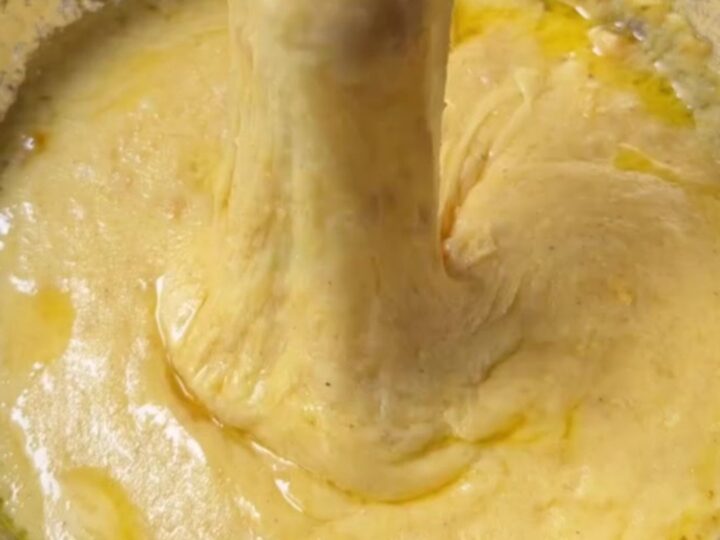 Black Sea kuymak in a copper pan with cheese pulling high on a fork